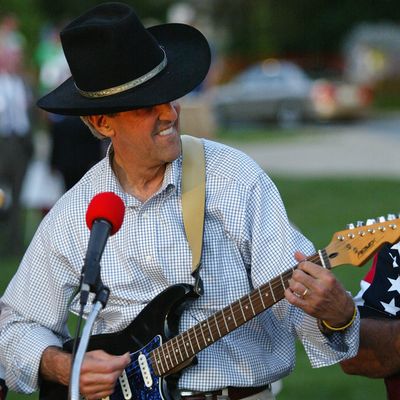 JEFFERSON CITY, MO - AUGUST 5: Democratic presidential nominee US Sen. John Kerry (D-MA) plays guitar during a rally August 5, 2004 in Jefferson City, Missouri. Kerry continues on the two-week, 3,500 mile 