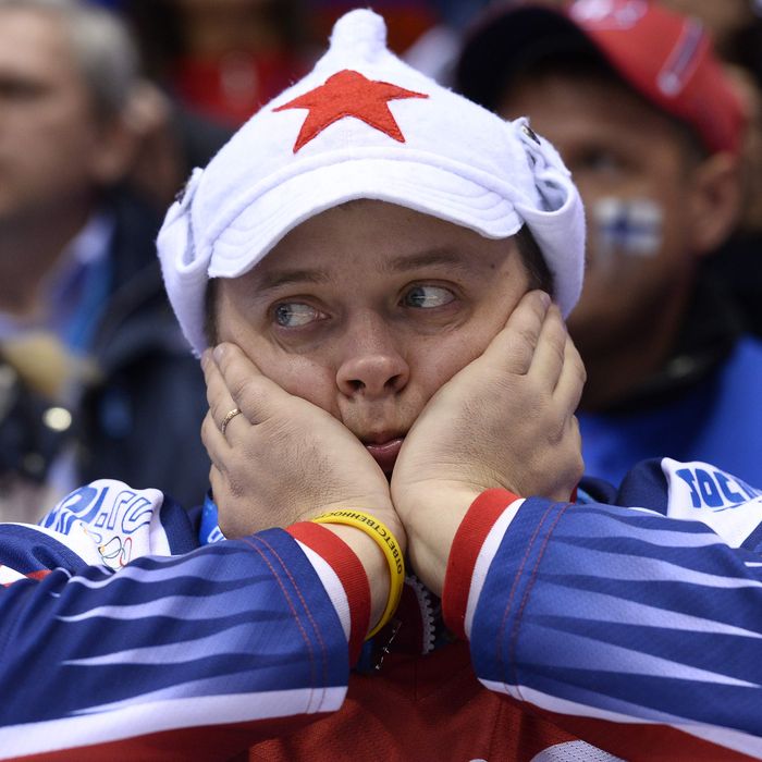 A Russian supporter reacts during the Men's Ice Hockey Play-offs Quarterfinals match between Finland and Russia at the Bolshoy Ice Dome during the Sochi Winter Olympics on February 19, 2014. Finland won 3-1. AFP PHOTO / JONATHAN NACKSTRAND (Photo credit should read JONATHAN NACKSTRAND/AFP/Getty Images)