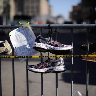 BOSTON, MA - APRIL 21: Running shoes are placed at a makeshift memorial for victims near the finish line of the Boston Marathon bombings at the intersection of Newbury Street and Darthmouth Street two days after the second suspect was captured on April 21, 2013 in Boston, Massachusetts. A manhunt for Dzhokhar A. Tsarnaev, 19, a suspect in the Boston Marathon bombing ended after he was apprehended on a boat parked on a residential property in Watertown, Massachusetts. His brother Tamerlan Tsarnaev, 26, the other suspect, was shot and killed after a car chase and shootout with police. The bombing, on April 15 at the finish line of the marathon, killed three people and wounded at least 170. (Photo by Kevork Djansezian/Getty Images)