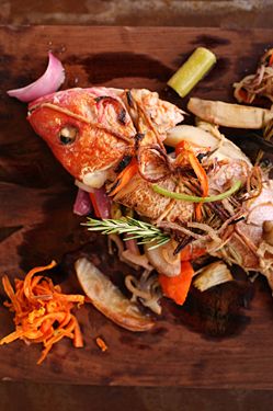 Roasted red snapper with rosemary and white wine sauce served with a side of seasonal grilled vegetables. Fish of the day will change at least twice a week according to what's available seasonally.