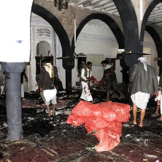 People inspect the crime scene at Al-Hashoush Mosque after a bombing attack in Al Jaraf region of Sana'a, Yemen on March 20, 2015. At least 55 people were killed on Friday in two bombings targeting Houthi mosques in Yemeni capital Sanaa, a medical source has said. The two blasts struck the Badr and Al-Hashoush mosques frequented by supporters of the Shiite Houthi militants. (Photo by Mohammed Hamoud/Anadolu Agency/Getty Images)