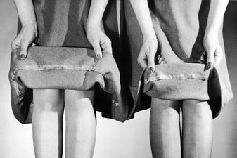 Two models lift the hems of their skirts to demonstrate the difference between a three-inch, pre-war hemline (at left) and the two-inch hemline adopted to save fabric during the course of the war, 1942. (Photo by Nina Leen/Pix Inc./The LIFE Picture Collection/Getty Images)