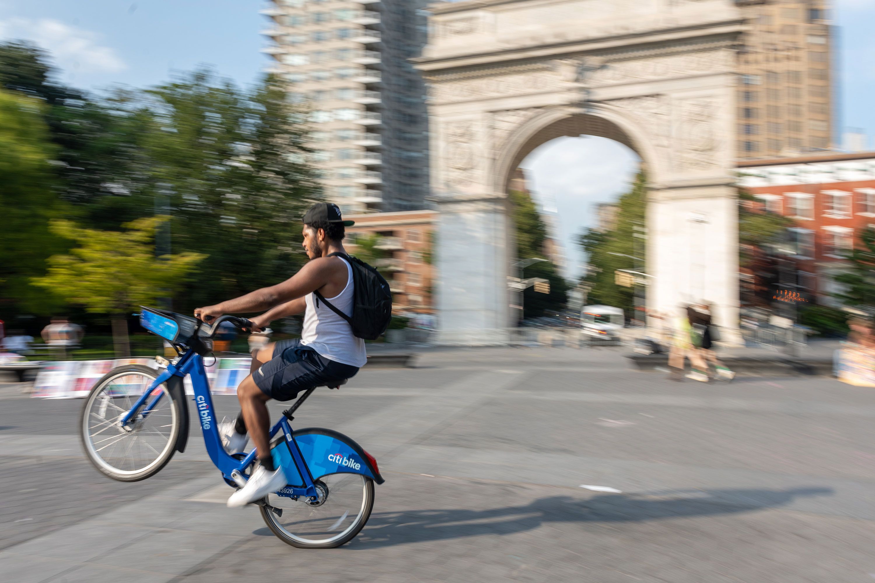 Donnie riding a bike and Leo riding a scooter