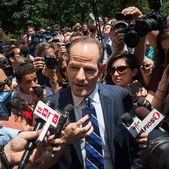 Former New York Gov. Eliot Spitzer is mobbed by reporters while attempting to collect signatures to run for comptroller of New York City on July 8, 2013 in New York City. 