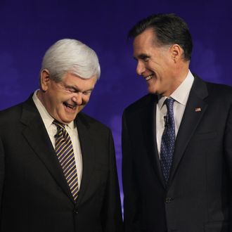 Newt Gingrich and Mitt Romney chat before a debate on November 9, 2011 in Rochester, Michigan.
