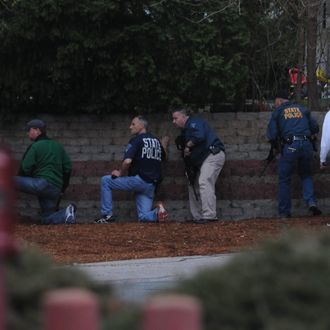 WATERTOWN, MA - APRIL 19: Law enforcement approach an area reportedly where a suspect is hiding on April 19, 2013 in Watertown, Massachusetts. After a car chase and shoot out with police, one suspect in the Boston Marathon bombing, Tamerlan Tsarnaev, 26, was shot and killed by police early morning April 19, and a manhunt is underway for his brother and second suspect, 19-year-old Dzhokhar A. Tsarnaev. The two men are suspects in the bombings at the Boston Marathon on April 15, that killed three people and wounded at least 170. (Photo by Darren McCollester/Getty Images)