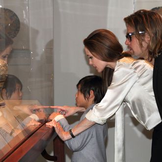 Art patrons and supporters, Angelina Jolie, Brad Pitt, and their son, Pax view works from LACMA's Chinese collection