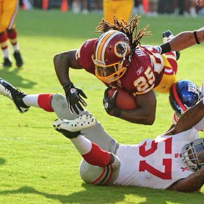 LANDOVER, MD - SEPTEMBER 11: Tim Hightower #25 of the Washington Redskins carries the ball against Jacquain Williams #57 of the New York Giants season-opening game at FedEx Field on September 11, 2011 in Landover, Maryland. (Photo by Scott Cunningham/Getty Images)