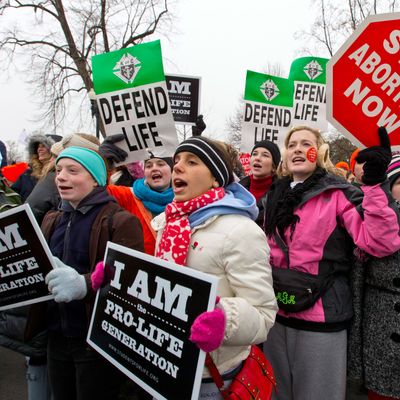 Anti-abortion activists march past the U.S. Supreme Court as they observe the 40th anniversary of the Roe v. Wade decision, in Washington, Friday, Jan. 25, 2013. 