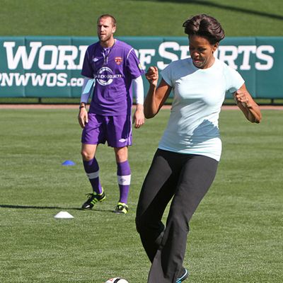 First lady Michelle Obama plays soccer during her visit to the ESPN Wide World of Sports Complex