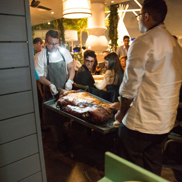 Chromeo checking out a roasted pig at the Vice x Art Basel dinner at the Mondrian.