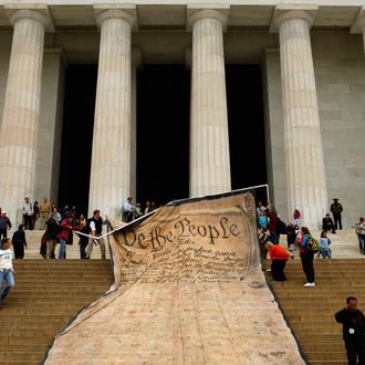 Volunteers unfurl a giant banner printed with the Preamble to the United States Constitution at the Lincoln Memorial.
