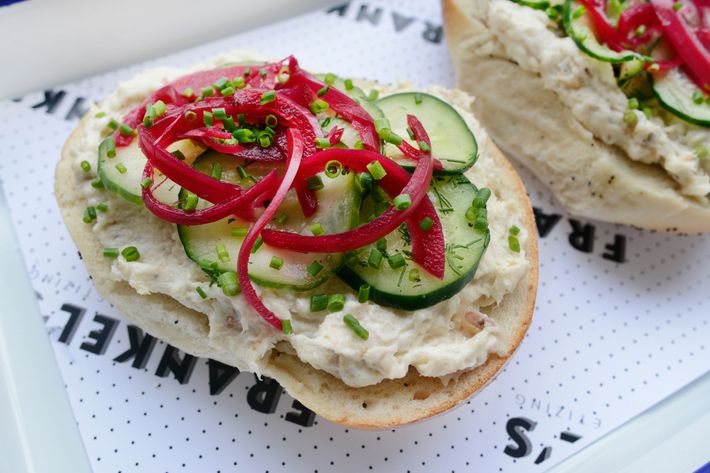 Bagel with whitefish salad, onions pickled in beet juice, and cucumbers.