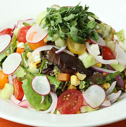 Field greens, tomato, avocado, feta, cucumber, roasted corn radish, red onion, and olive vinaigrette.