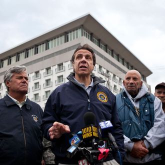 LONG BEACH, NY - OCTOBER 31: New York Governor Andrew Cuomo (3rd L) speaks to members of the media about recovering efforts after Hurricane Sandy, on October 31, 2012 in Long Beach, New York. Businesses across the eastern seaboard are attempting to return to normal operations as clean-up from Hurricane Sandy continues. (Photo by Andrew Burton/Getty Images)