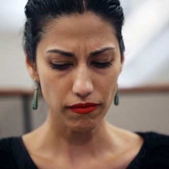 NEW YORK, NY - JULY 23: Huma Abedin, wife of Anthony Weiner, a leading candidate for New York City mayor, listens as her husband speaks at a press conference on July 23, 2013 in New York City. Weiner addressed news of new allegations that he engaged in lewd online conversations with a woman after he resigned from Congress for similar previous incidents. (Photo by John Moore/Getty Images)