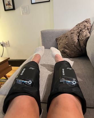 Ashley Wolfgang wearing the Normatec Go on her calves.