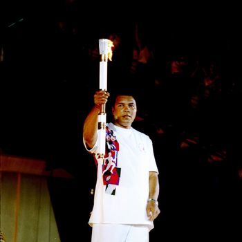 Muhammad Ali holds the torch before lighting the Olympic Flame during the Opening Ceremony of the 1996 Centennial Olympic Games in Atlanta, Georgia.