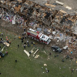 WEST, TX - APRIL 18: Search and rescue workers comb through what remains of a 50-unit apartment building the day after an explosion at the West Fertilizer Company destroyed the building April 18, 2013 in West, Texas. According to West Mayor Tommy Muska, around 14 people, including 10 first responders, were killed and more than 150 people were injured when the fertilizer company caught fire and exploded, leaving damaged buildings for blocks in every direction. (Photo by Chip Somodevilla/Getty Images)