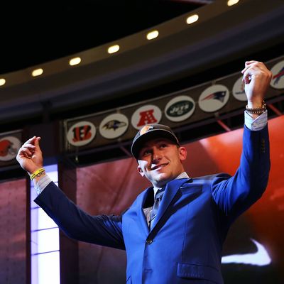 NEW YORK, NY - MAY 08: Johnny Manziel of the Texas A&M Aggies takes the stage after he was picked #22 overall by the Cleveland Browns during the first round of the 2014 NFL Draft at Radio City Music Hall on May 8, 2014 in New York City. (Photo by Elsa/Getty Images)