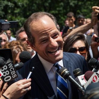 Former New York Gov. Eliot Spitzer is mobbed by reporters while attempting to collect signatures to run for comptroller of New York City on July 8, 2013 in New York City. Spitzer resigned as governor in 2008 after it was discovered that he was using a high end call girl service. 