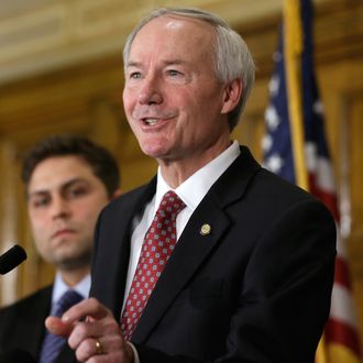 Arkansas Gov. Asa Hutchinson, right, answers reporters' questions as Sen. Jonathan Dismang, R-Beebe, lisens at the state Capitol in Little Rock, Ark., Wednesday, April 1, 2015. Hutchinson on Wednesday called for changes to the state's religious objection measure facing a backlash from businesses and gay rights groups, saying it wasn't intended to sanction discrimination based on sexual orientation. (AP Photo/Danny Johnston)