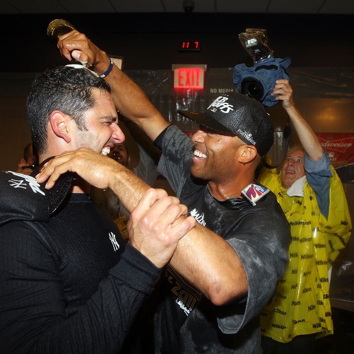 NEW YORK, NY - SEPTEMBER 21: Jorge Posada #20 and Mariano Rivera #42 of the New York Yankees celebrate after clinching the American League East division against the Tampa Bay Rays on September 21, 2011 at Yankee Stadium in the Bronx borough of New York City. (Photo by Jim McIsaac/Getty Images)