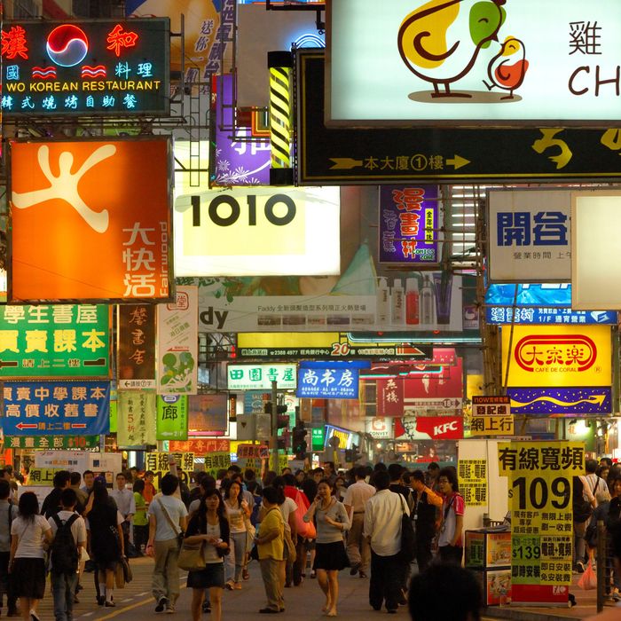 Hong Kong, China. 12th Feb, 2022. Shoppers walk past a commercial