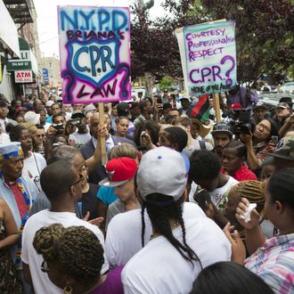 19 Jul 2014, New York City, New York State, USA --- Demonstrators gather at the site of Eric Garner's death on a march following a service held in his name at the Mount Sinai Center for Community Enrichment, Saturday, July 19, 2014, in New York. in the Staten Island borough of New York. 