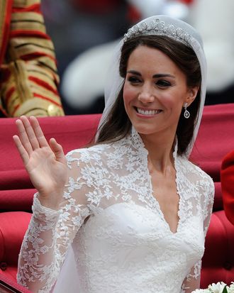 Catherine, Duchess of Cambridge waves as she travels beside husband Prince William, Duke of Cambridge in the 1902 State Landau carriage on the procession route along The Mall to Buckingham Palace after their wedding ceremony at Westminster Abbey on April 29, 2011 in London, England. The marriage of the second in line to the British throne was led by the Archbishop of Canterbury and was attended by 1900 guests, including foreign Royal family members and heads of state. Thousands of well-wishers from around the world have also flocked to London to witness the spectacle and pageantry of the Royal Wedding.