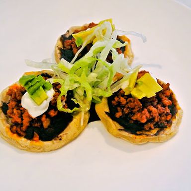 House-made thick corn tortilla, chorizo, beans, lettuce, avocado, and cream