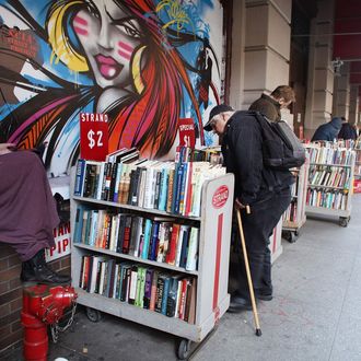 People browse through books outside of the Strand Bookstore on April 2, 2012 in New York City. Workers and owners of the Strand are in a contract dispute over healthcare contributions, a two-tier wage system and other benefits. Part of the United Autoworker's Union, the store's 140 non-management employees will vote on a new contract this week. 