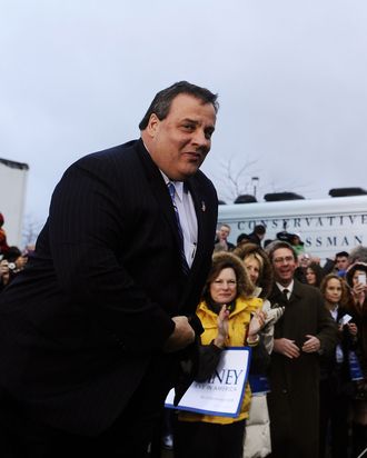 New Jersey Governor Chris Christie looks on during a campaign rally outside a grocery store in Des Moines, Iowa, on December 30, 2011. Romney on Friday ripped President Barack Obama over his annual Hawaii vacation, painting him as out of touch with Americans' economic suffering. 