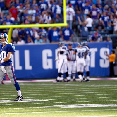 EAST RUTHERFORD, NJ - OCTOBER 09: Eli Manning #10 of the New York Giants walks to the bench after throwing an interception that went for a touchdown during a game against the Seattle Seahawks at MetLife Stadium on October 9, 2011 in East Rutherford, New Jersey. (Photo by Jeff Zelevansky/Getty Images)