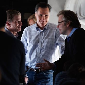 Republican presidential candidate and former Massachusetts Governor Mitt Romney (C) talks with campaign advisors Stuart Stevens (L) and Eric Fehrnstrom on a chartered airplane after departing Des Moines, Iowa, January 4, 2012 while en route to Manchester, New Hampshire.