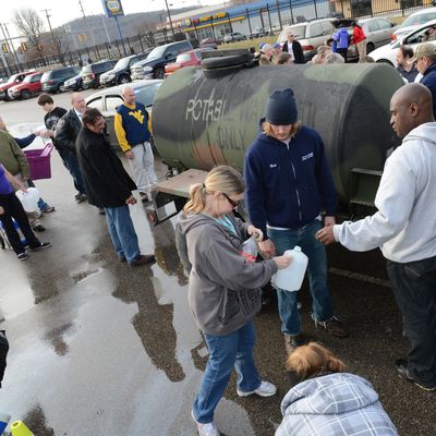 SOUTH CHARLESTON, WV - JANUARY 10: West Virginia American Water customers line up for water at the Gestamp Plant after waiting hours for a water truck, only to have it empited in about 20 minutes on January 10, 2014 in South Charleston, West Virginia. West Virginia American Water determined Thursday MCHM chemical had 