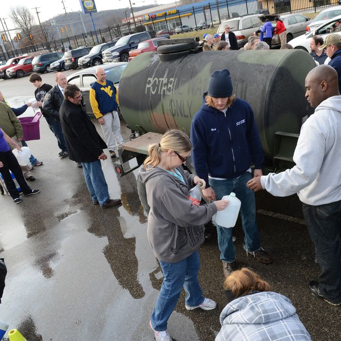 SOUTH CHARLESTON, WV - JANUARY 10: West Virginia American Water customers line up for water at the Gestamp Plant after waiting hours for a water truck, only to have it empited in about 20 minutes on January 10, 2014 in South Charleston, West Virginia. West Virginia American Water determined Thursday MCHM chemical had