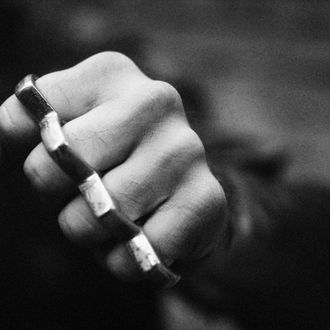 Hand With Brass Knuckles, Close-up, B&w --- Image by ? Laurent Hamels/PhotoAlto/Corbis