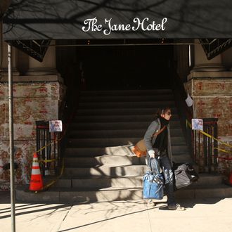 A guest walks out of the Jane Hotel, a new hotel built around the concept of budget conscious travel with style on March 23, 2009 in New York City. Opening in stages until the end of the summer, the Jane Hotel will offer approximately 150 small rooms-7 feet wide by eight feet long- at less than $100 per night and slightly larger 