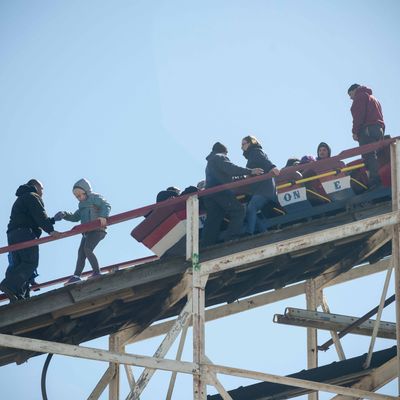 Workers assist thrill seekers on the Luna Park Coney Island Cyclone roller coaster after it got stuck on its inaugural run of the Summer 2015 season. The rescue involved walking down the ties. -- The Coney Island Cyclone roller coaster got stuck on its inaugural run of the Summer season. The train stopped just short of the initial drop. The first riders had to escorted down the landmark wooden coaster after being stuck for about 5 minutes. 