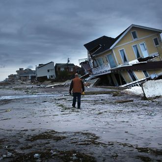 NEW YORK, NY - OCTOBER 31: Damage is viewed in the Rockaway neighborhood where the historic boardwalk was washed away during Hurricane Sandy on October 31, 2012 in the Queens borough of New York City. With the death toll currently at 55 and millions of homes and businesses without power, the US east coast is attempting to recover from the affects of floods, fires and power outages brought on by Hurricane Sandy. JFK airport in New York and Newark airport in New Jersey expect to resume flights on Wednesday morning and the New York Stock Exchange commenced trading after being closed for two days. (Photo by Spencer Platt/Getty Images)