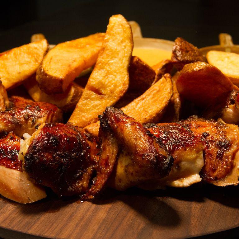 The whole-roasted chicken with fried potatoes and assorted aji sauces feeds two, maybe three.