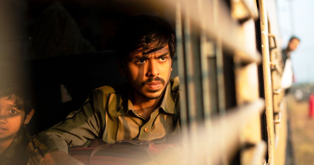 Balram as poor, reflecting out the window during a train ride in the beginning of the film