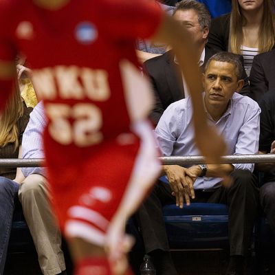 US President Barack Obama (2nd R) and British Prime Minister David Cameron (R) watch Mississippi Valley State University play against Western Kentucky University at the University of Dayton Arena in Dayton, Ohio, March 13, 2012.
