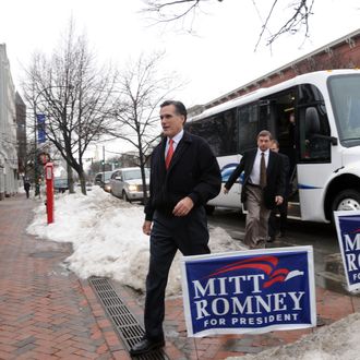 Republican presidential candidate and former Massachusetts Governor Mitt Romney (R) exits his campaign bus along Main Street December 27, 2007 in Nashua, New Hampshire.