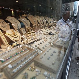 NEW YORK, NY - JULY 18: A man views gold items for sale in the Diamond District of Manhattan on July 18, 2011 in New York City. The price of gold rose above $1600 an ounce today, setting a new all-time record. (Photo by Mario Tama/Getty Images)