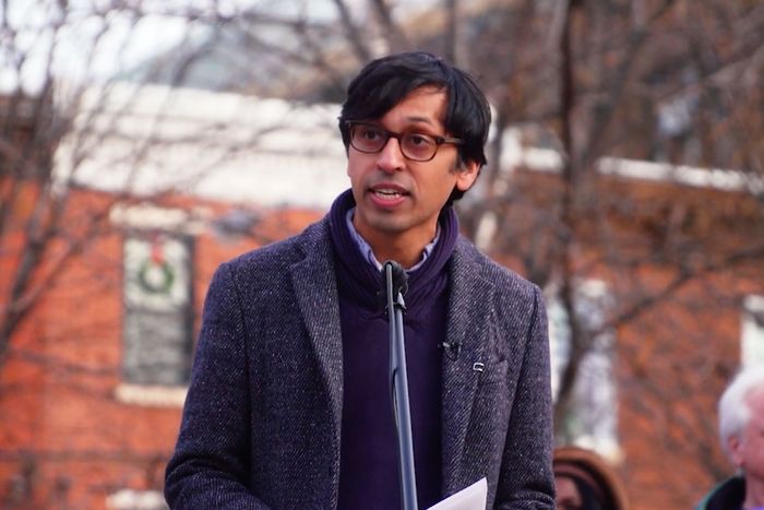 A portrait of Nikil Saval addressing a crowd, mid speech