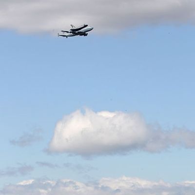 NEW YORK, NY - APRIL 27: Space shuttle Enterprise, mounted atop a 747 shuttle carrier aircraft, flies past the Statue of Liberty prior to landing at John F. Kennedy International Airport on April 27, 2012 in New York City. Enterprise, which was flown from Washington, DC, will eventually be put on permanent display at the Intrepid Sea, Air and Space Museum. (Photo by Michael Heiman/Getty Images)