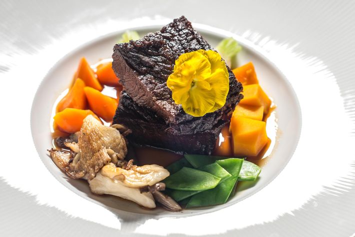 Sake-braised short rib with pan-seared foie gras, oyster mushrooms, and sugar snap peas.