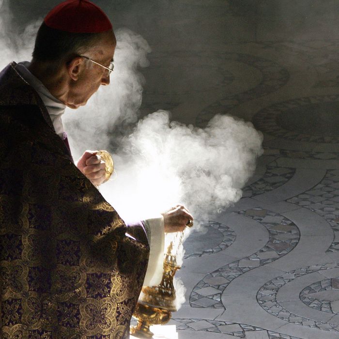A Catholic cardinal waving incense.